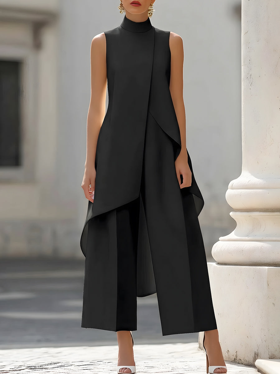 Black sleeveless jumpsuit with layered design in elegant urban setting.
