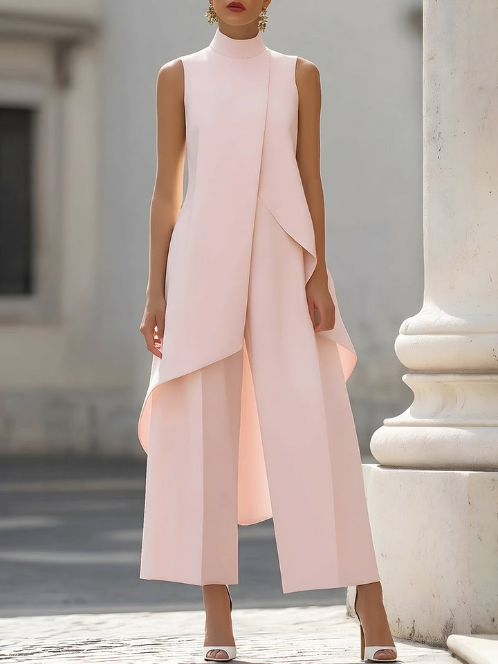 Soft pink sleeveless jumpsuit with layered design in an urban environment.