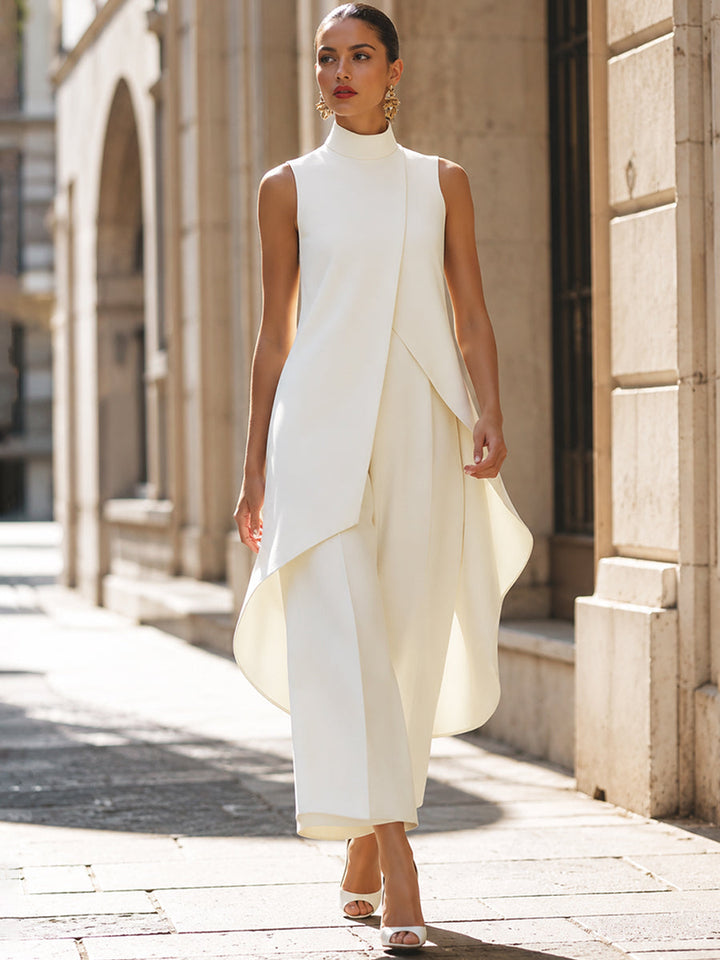 Elegant white jumpsuit with layered design in a sunlit urban street.