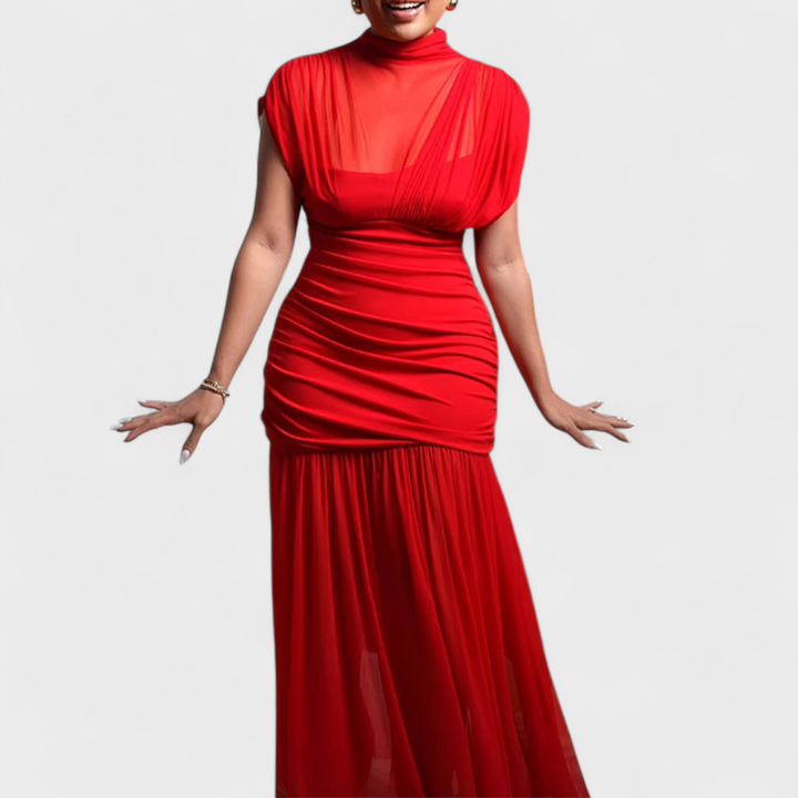 Red elegant dress with gathered detailing and a sheer top, worn by model in studio.