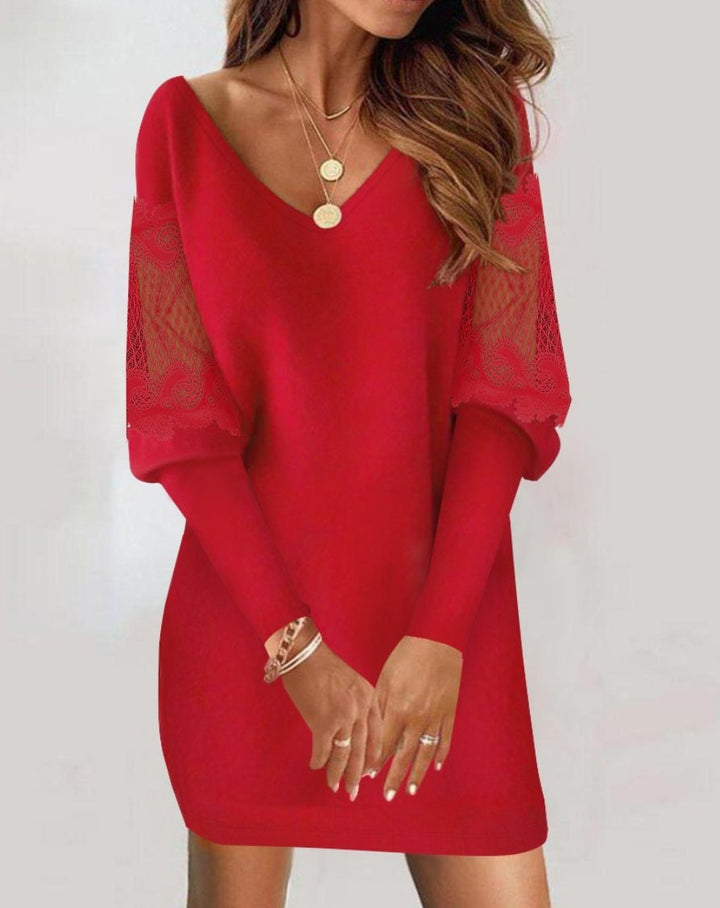 Stylish red lace dress with intricate sheer sleeve designs, paired with gold necklaces, grey background.