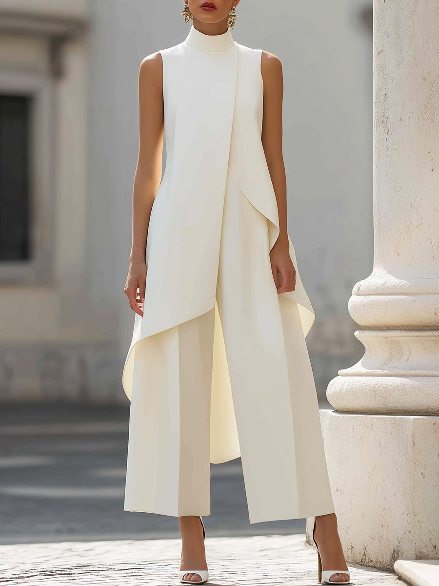 White sleeveless jumpsuit with layered design in elegant urban setting.