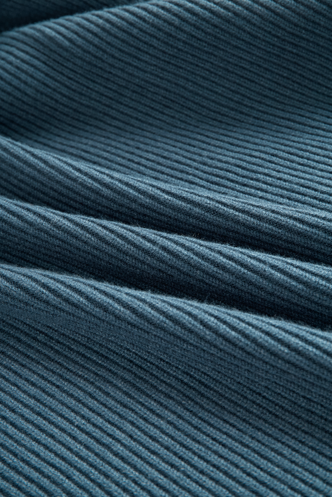 Detailed view of blue ribbed-knit fabric from a maxi dress, showcasing texture and weave.