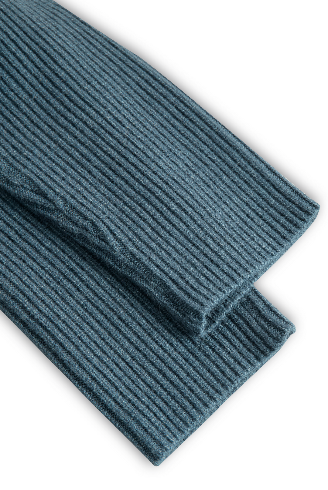 Close-up of blue ribbed-knit fabric from a maxi dress folded neatly.