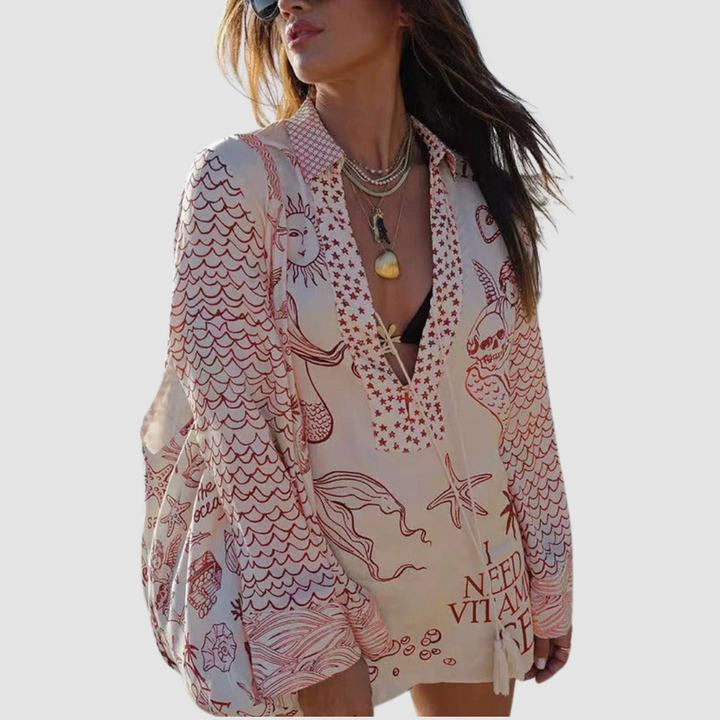 Model wearing red patterned two-piece set, grey background.