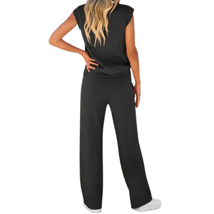 Back view of black casual lounge set with wide-leg pants and sleeveless top, studio setting.
