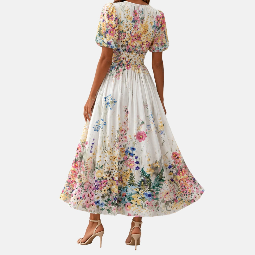Back view of floral midi dress with puff sleeves in a studio setting. Model&