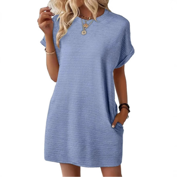 Light blue casual dress with a relaxed fit and short sleeves, modeled with necklaces and bracelets in a studio.
