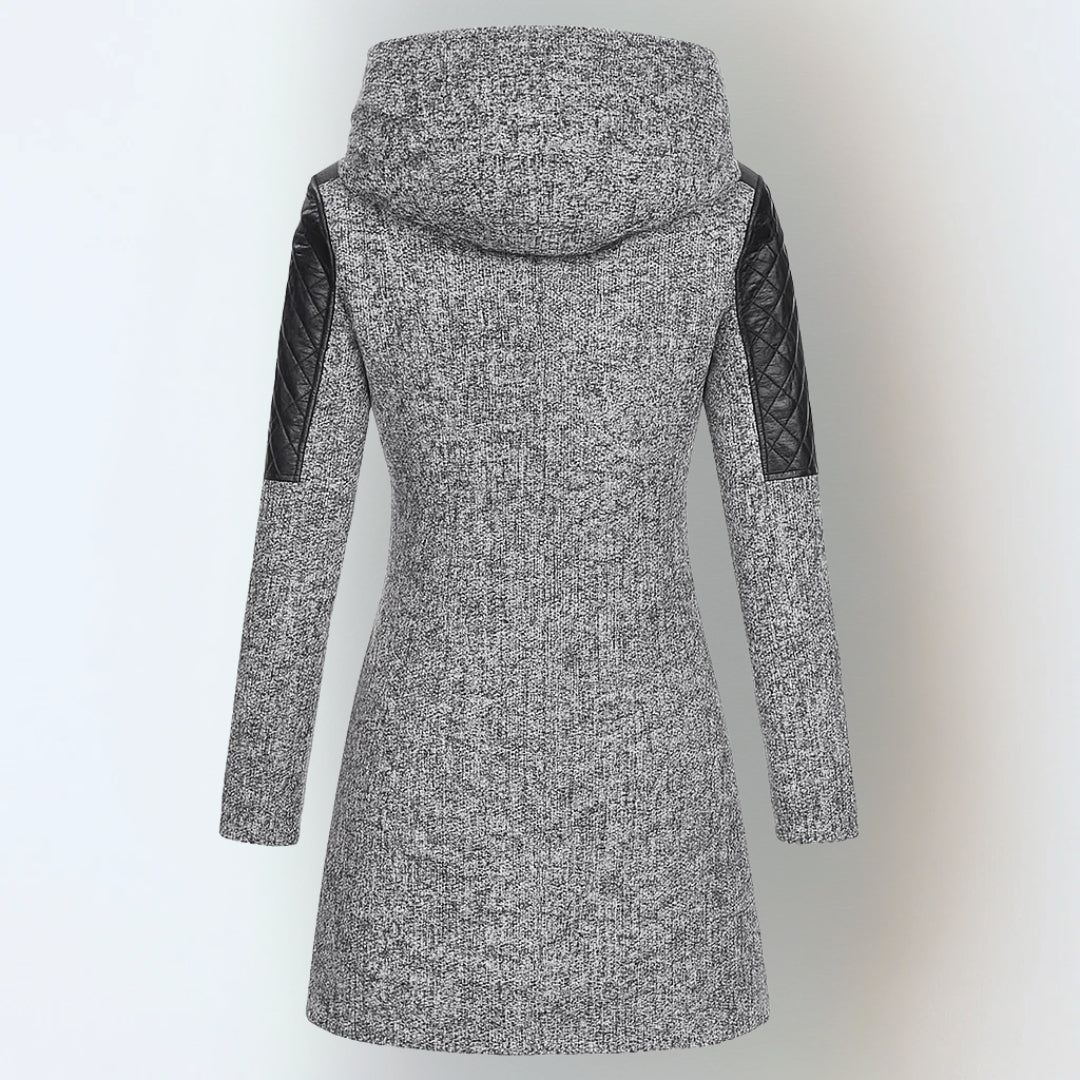 Back view of grey hooded winter jacket with black quilted accents, studio background.