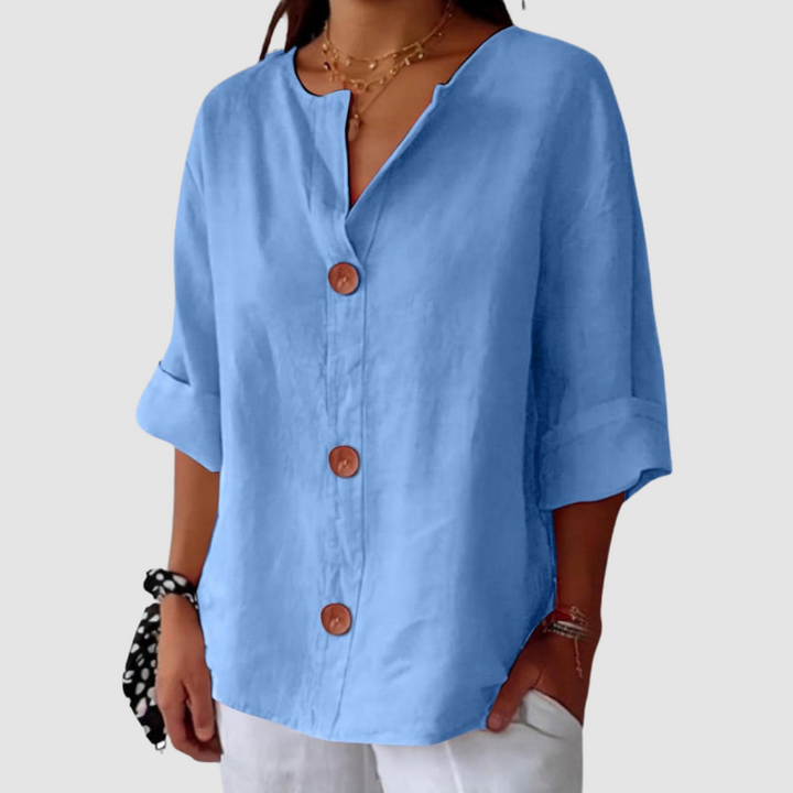 Light blue casual blouse, easy fit with button front, on a white background.