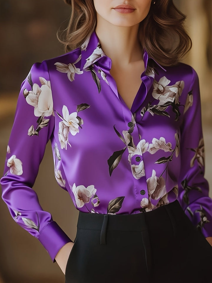 Elegant purple satin blouse with floral design, worn by model indoors with a neutral background.