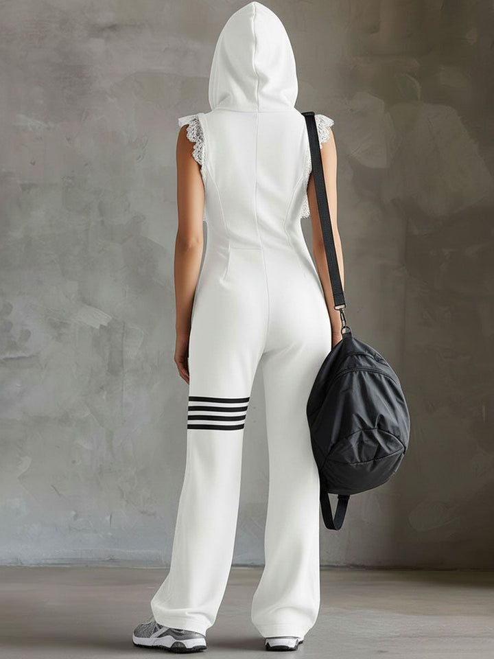 Back view of model in white hooded jumpsuit, holding bag, studio backdrop.