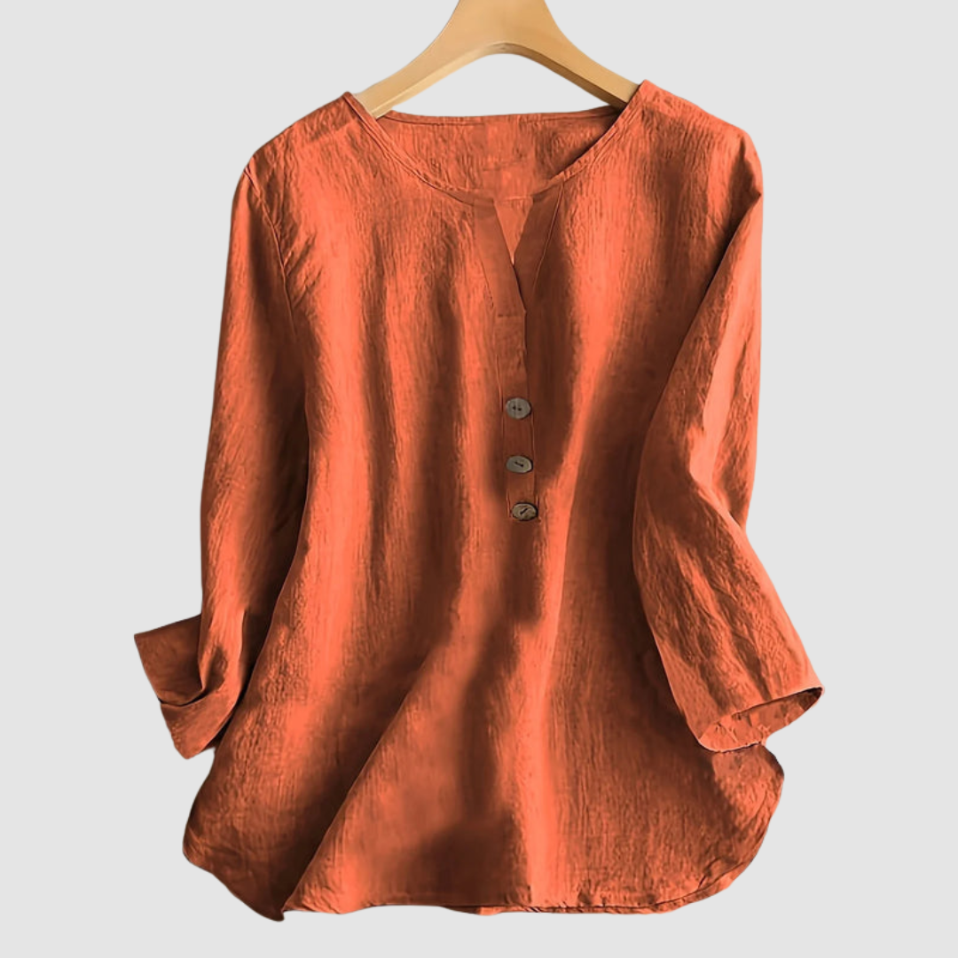 Rust casual blouse with button detail displayed on a hanger against a plain background.