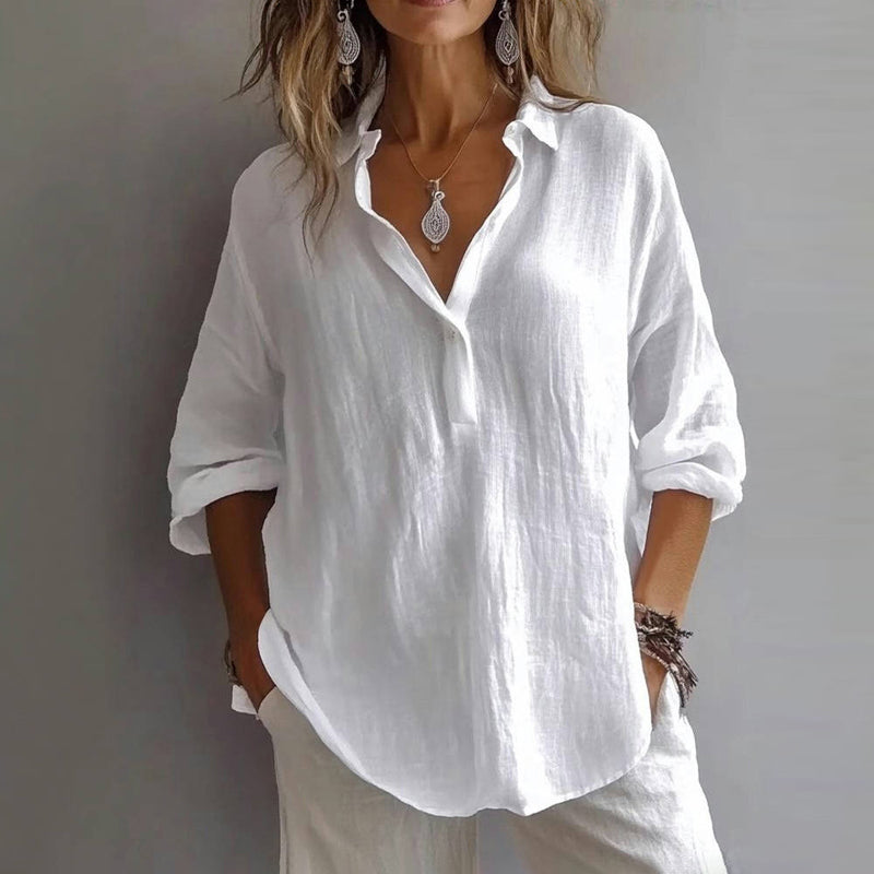 Elegant white blouse with a flowing design, featuring rolled-up sleeves and a relaxed fit against a simple gray background.