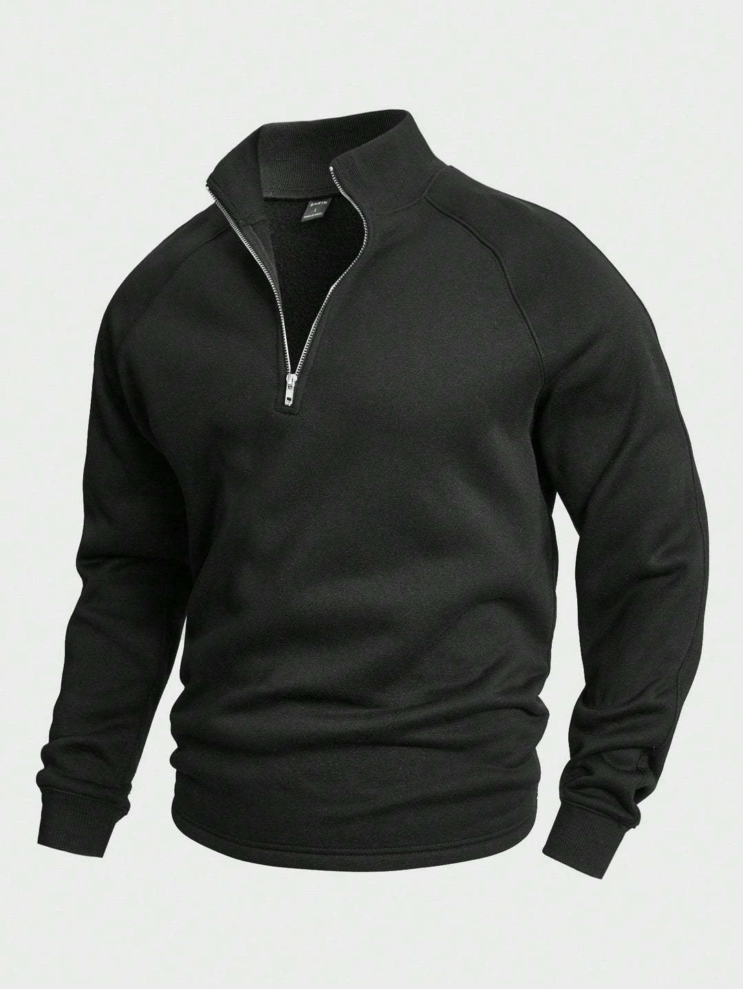 Black zip sweater with high collar and long sleeves, displayed in a studio setting.