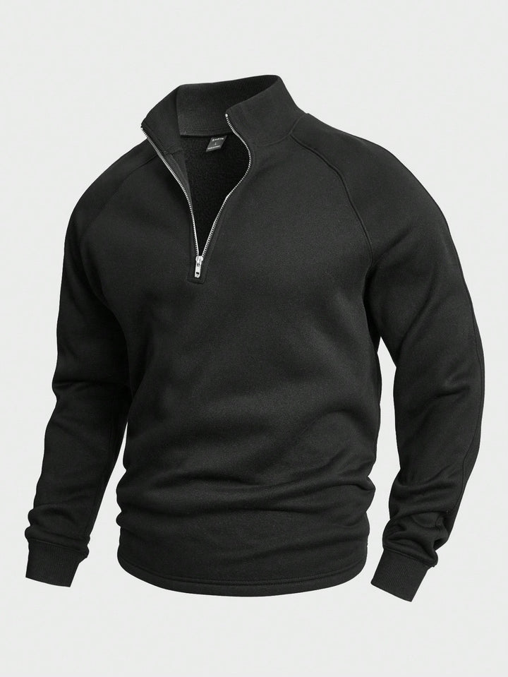 Black zip sweater with high collar and long sleeves, displayed in a studio setting.