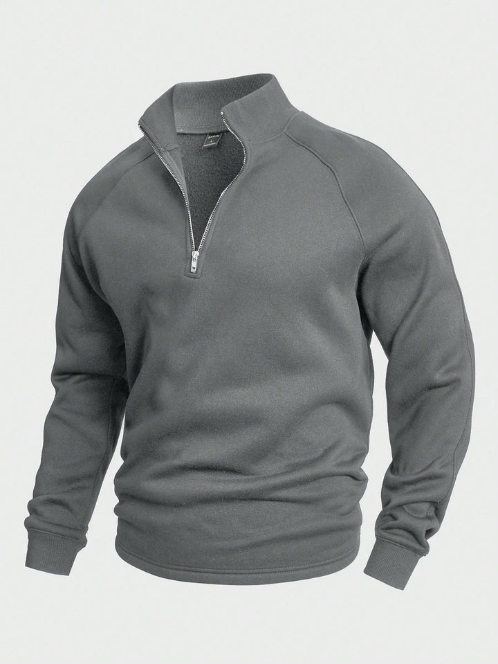 Gray zip sweater with high collar and long sleeves, presented in a studio setting.