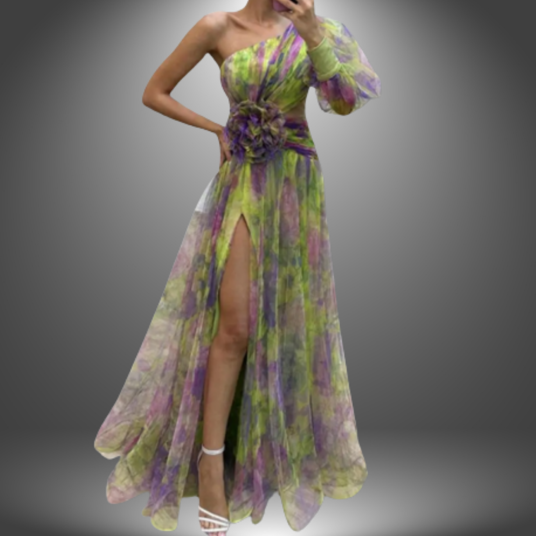 Green and purple elegant dress with one shoulder design, floral detail at the waist, and thigh slit in a studio setting.