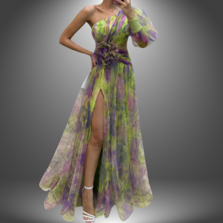 Green and purple elegant dress with one shoulder design, floral detail at the waist, and thigh slit in a studio setting.
