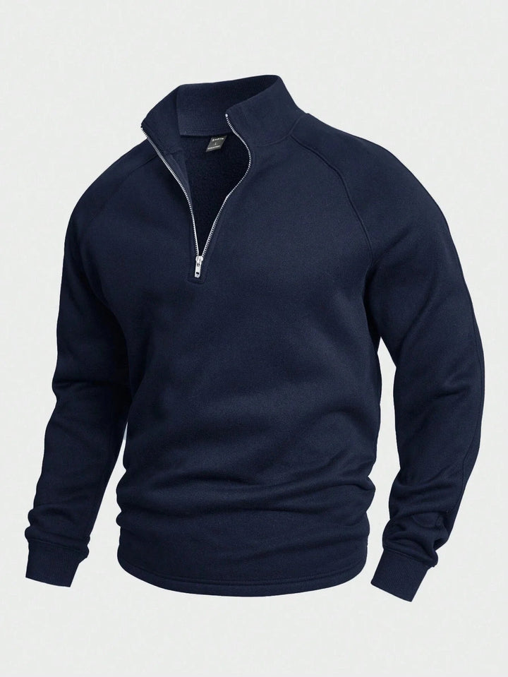 Navy blue zip sweater with high collar and long sleeves, shown in a studio setting.