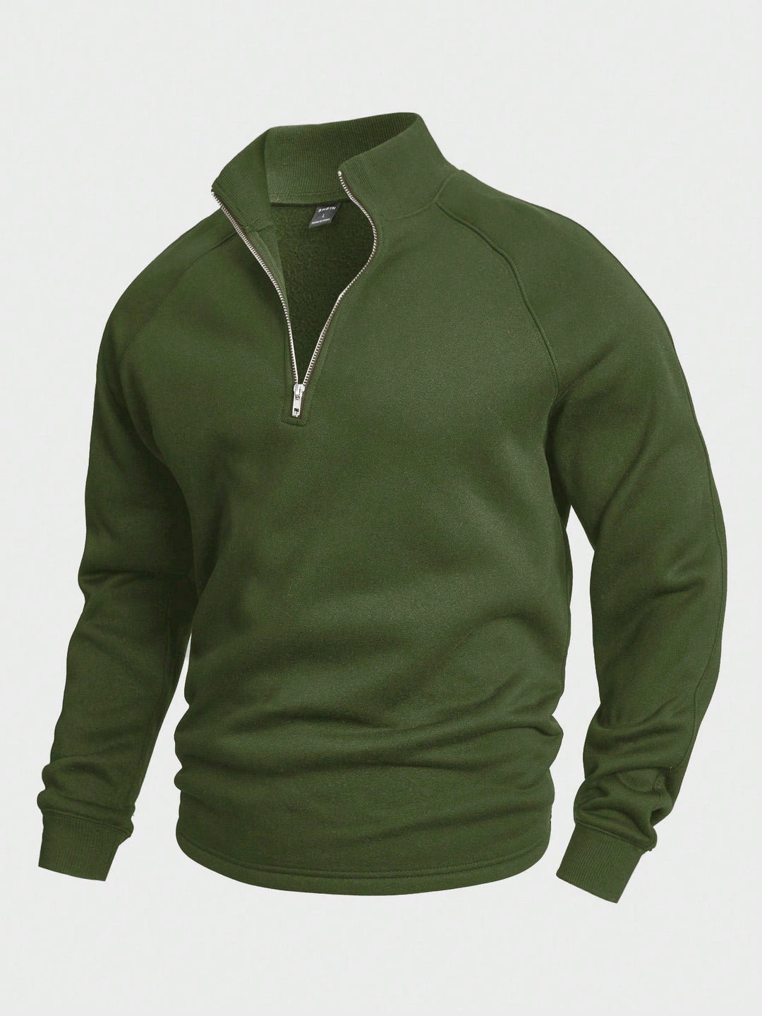 Green zip sweater with high collar and long sleeves, featured in a studio setting.