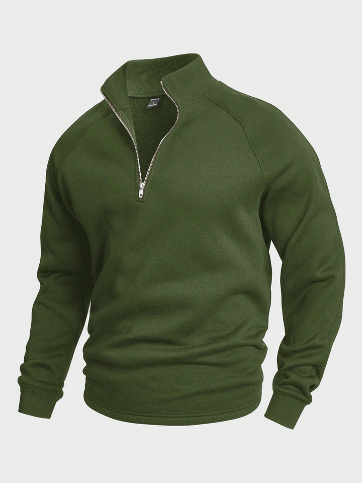 Green zip sweater with high collar and long sleeves, featured in a studio setting.