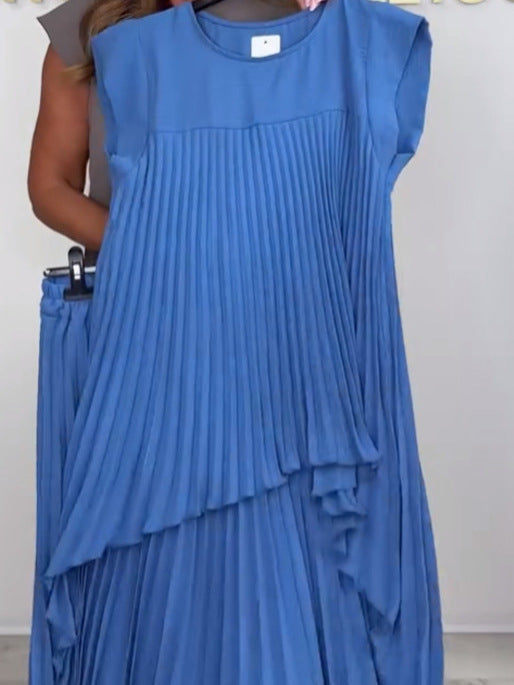 Blue pleated midi top and pants set on a hanger, displayed in a studio with a neutral background.