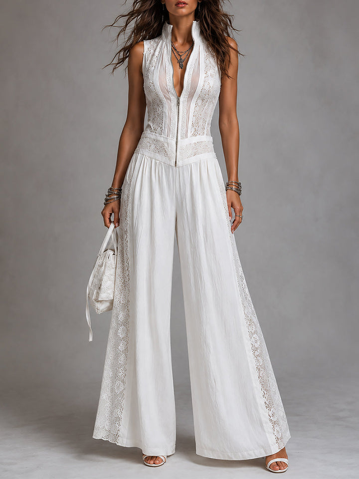 White stand-collar jumpsuit with lace trim and wide-leg pants, modeled in a studio setting.