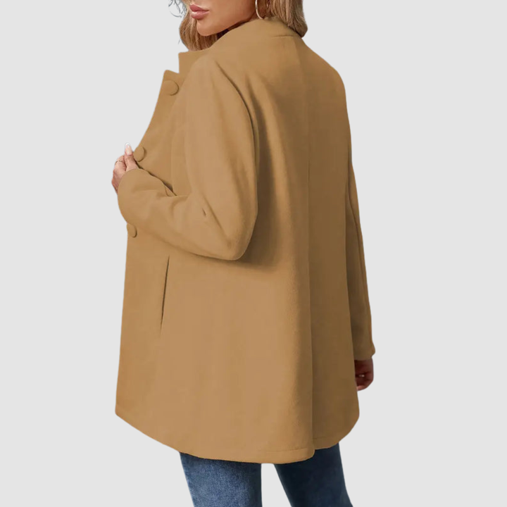 Back view of brown jacket with large buttons, worn over jeans, against a plain background.