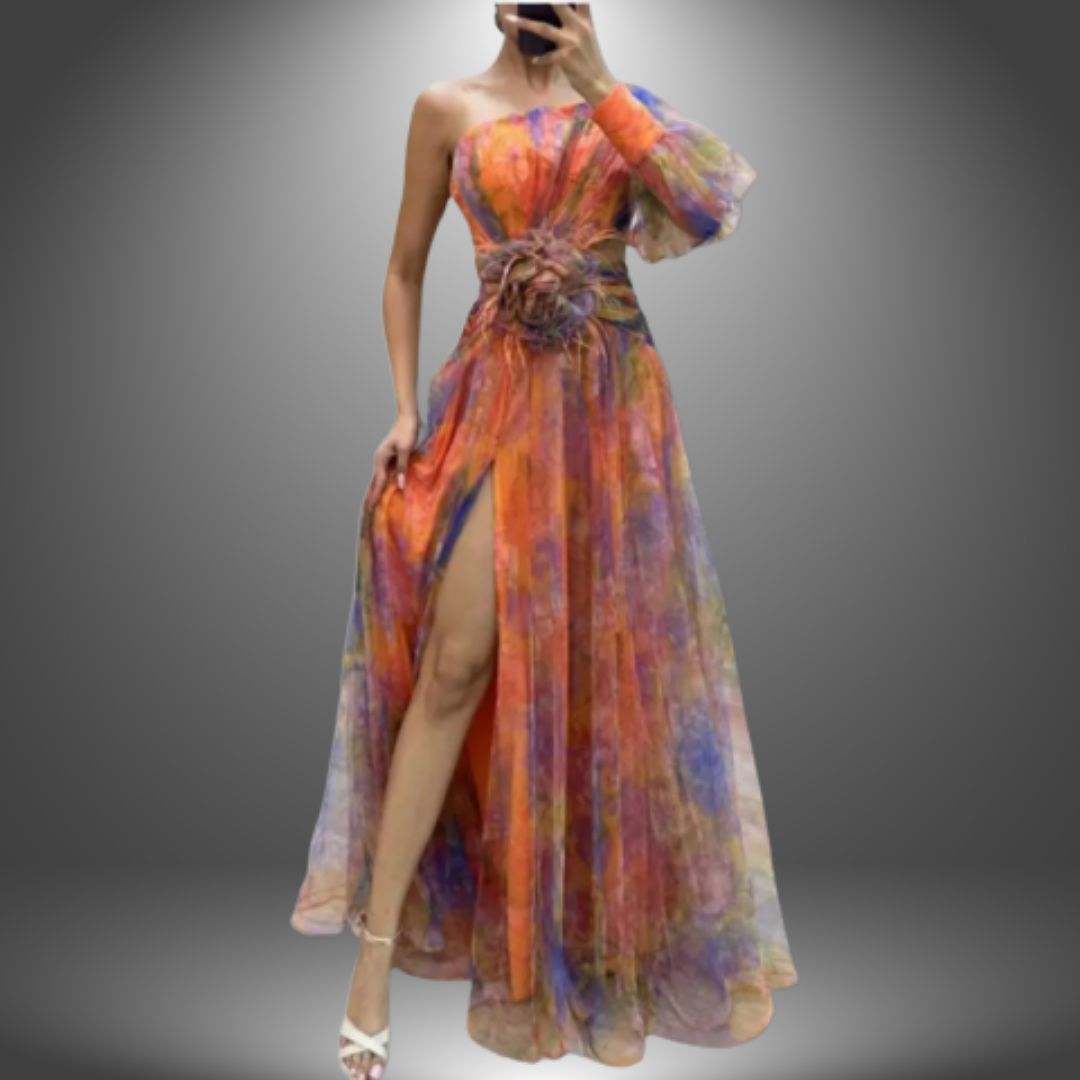 Elegant multicolored dress with one shoulder design, floral waist detail, and thigh-high slit in a gradient studio background.