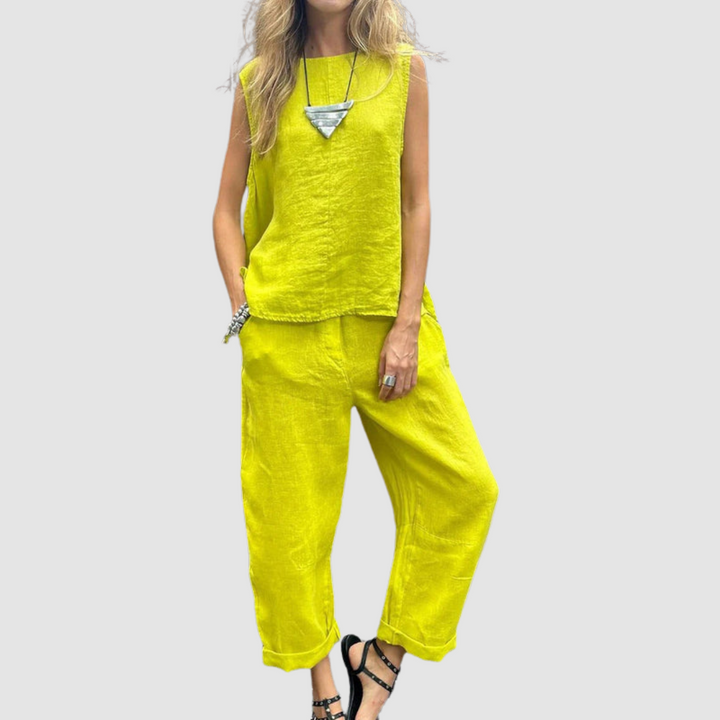 Bright yellow two-piece summer set with sleeveless top and loose pants, worn by model, gray background.