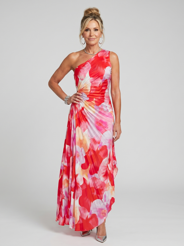 Model in red floral one-shoulder midi dress with pleated bodice in studio setting.