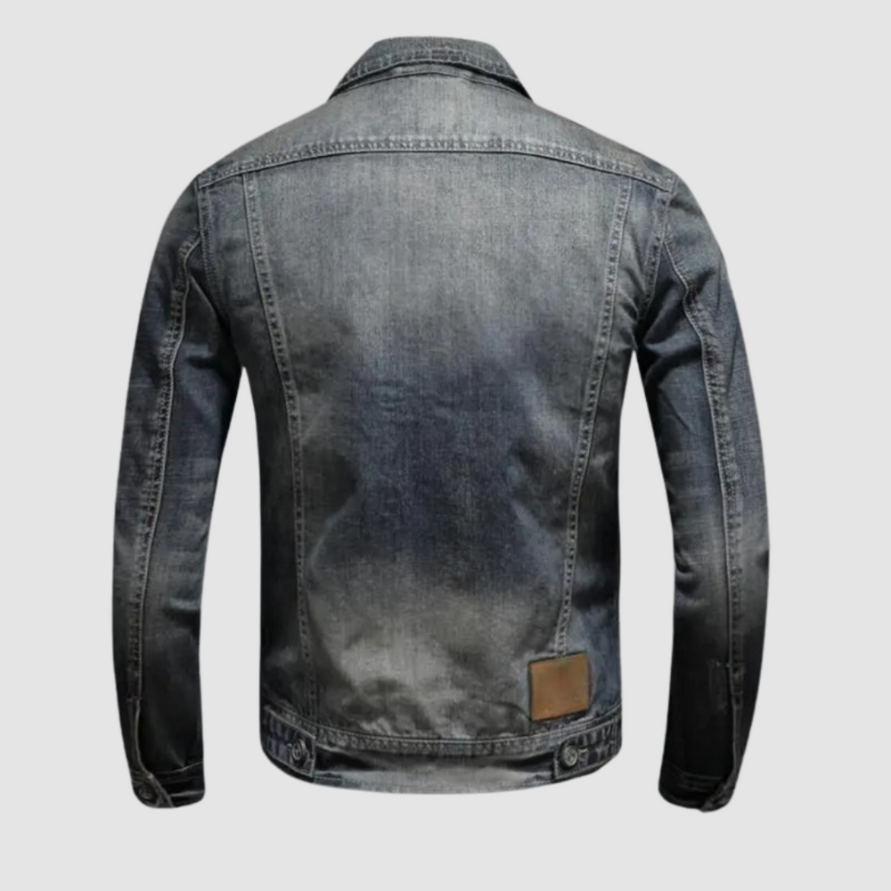 Back view of classic denim jacket showing stitching details on plain background.