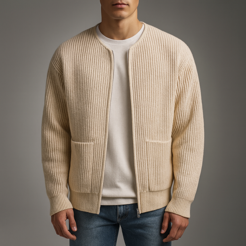 Model in cream knit zip cardigan over white shirt and jeans in a studio environment.