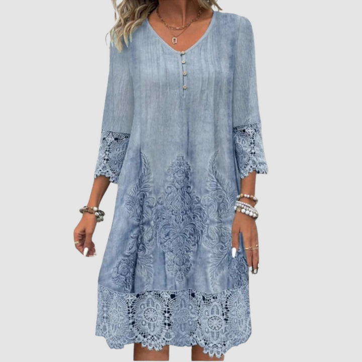 Elegant blue lace dress with V-neck, button details, and intricate lace patterns on hem and sleeves, studio background.