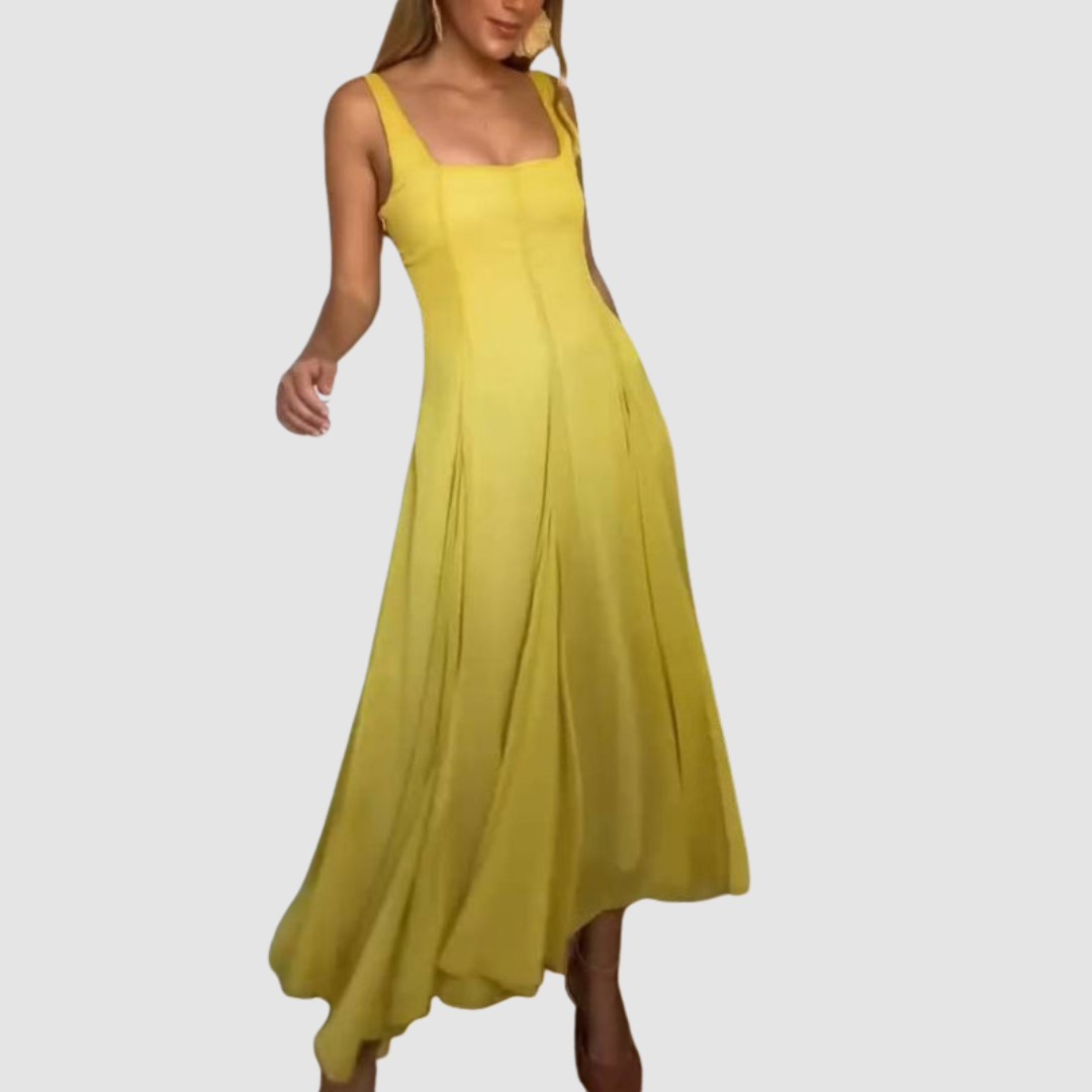 Yellow strappy maxi dress shown from the front, flowing design, worn by a model in a studio.