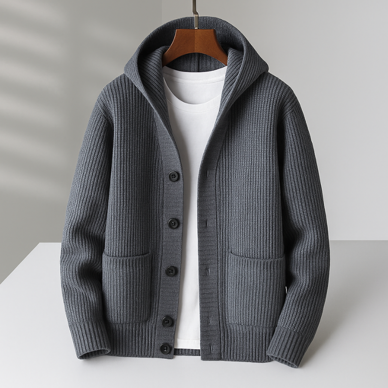 Gray hooded cardigan with black buttons on hanger in a bright studio setting.