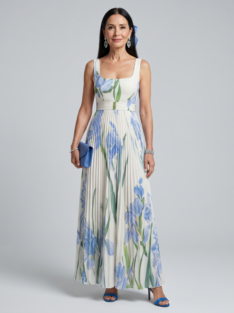 Woman in floral print midi dress with square neck, holding blue clutch in studio.