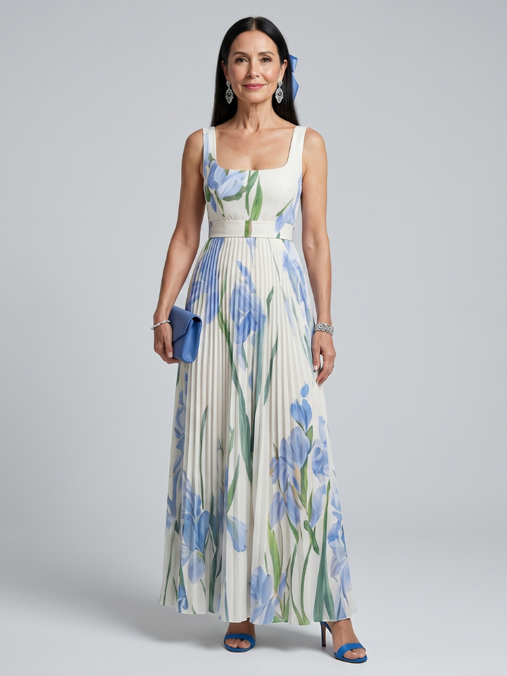 Woman in floral print midi dress with square neck, holding blue clutch in studio.