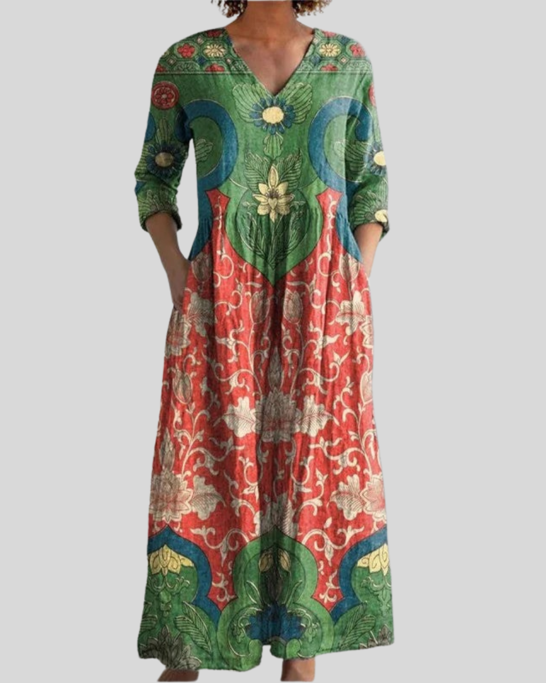 Vintage floral long dress with colorful patterns, featuring green, red, and blue tones, studio background.