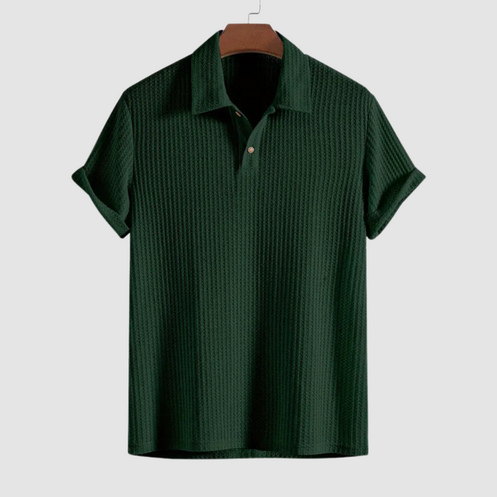 Dark green textured polo shirt on a hanger against a plain light gray background.