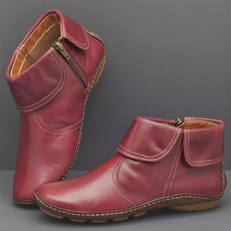 Red orthopedic waterproof boots with side zippers displayed against a gray background.