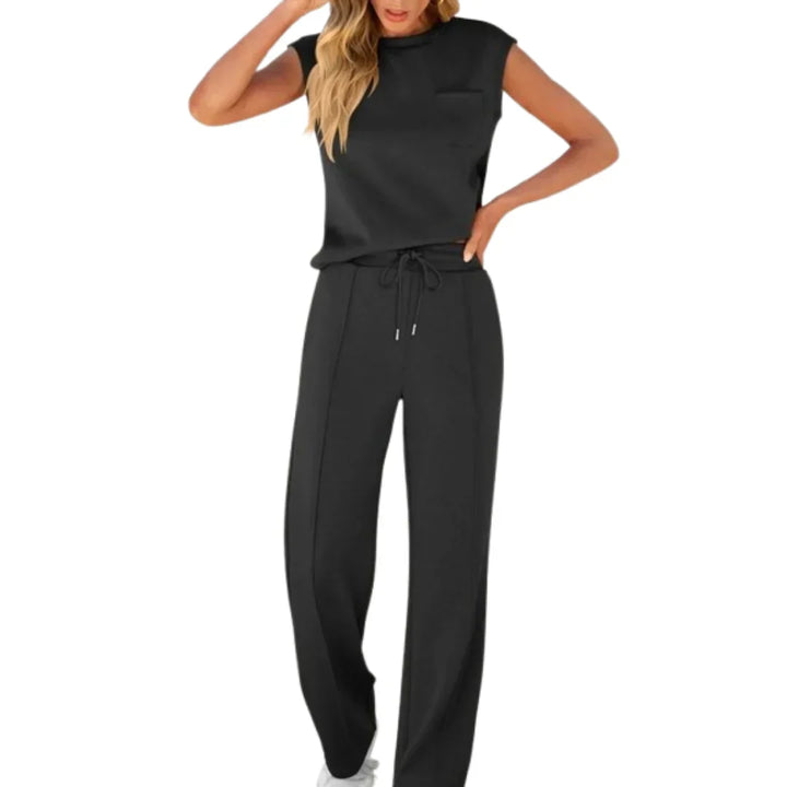 Black casual lounge set with sleeveless top and drawstring pants, studio setting.