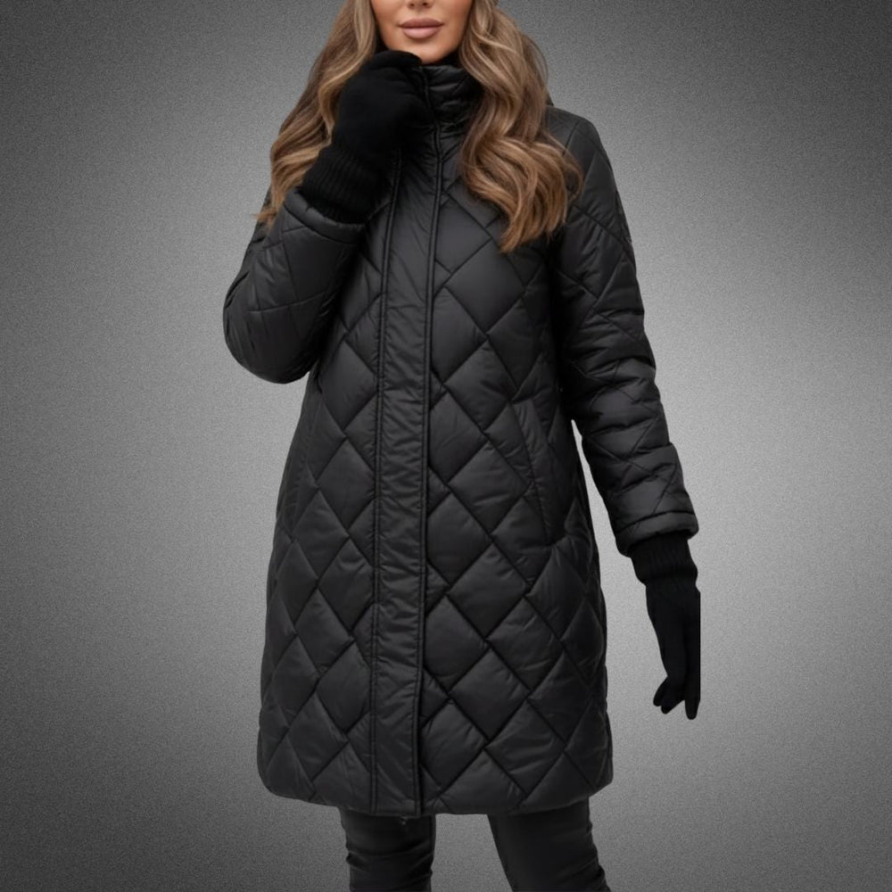 Woman in black quilted jacket with full zip in studio, hands in pockets, on a gradient background.
