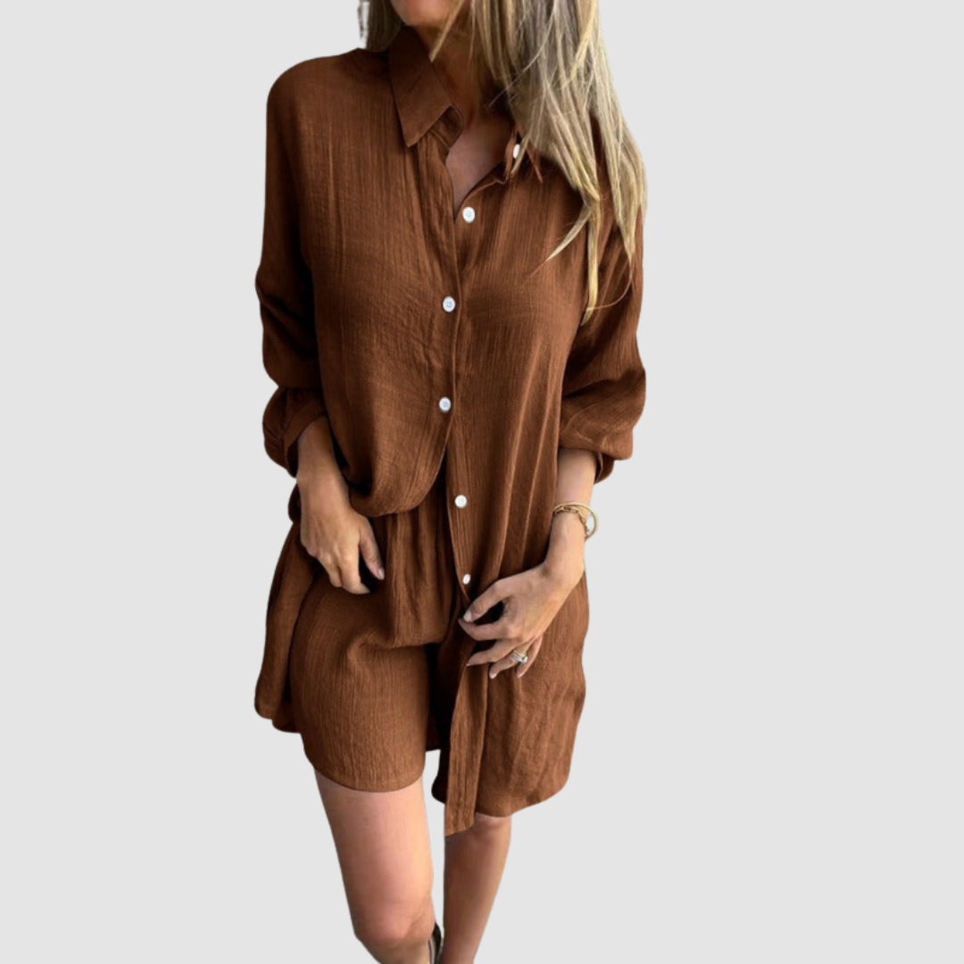 Model wearing a brown two-piece set with button-up shirt and shorts; neutral studio background.
