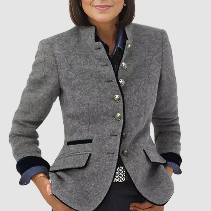 Women wearing a tailored, gray blazer with button details and black accents, against a white background.