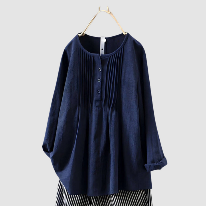 Elegant dark blue blouse with pleated front and button details, displayed on a hanger against a plain background.