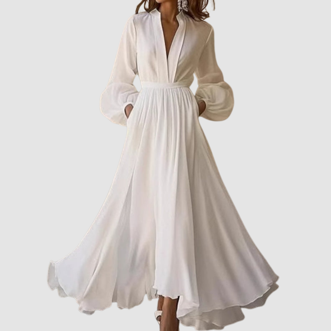 White V-neck ruffled maxi dress with long sleeves, flowing silhouette. Studio background.