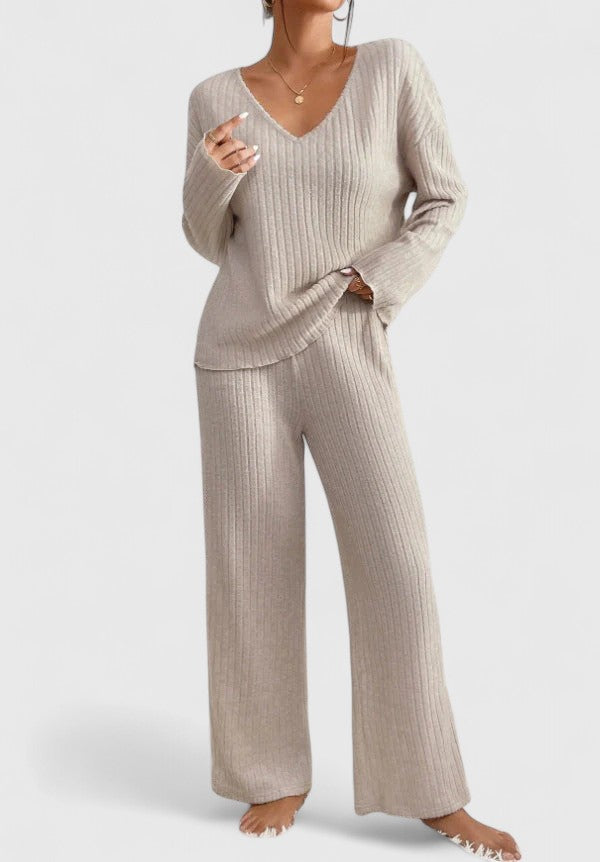 Beige ribbed V-neck long-sleeve top and matching wide-leg pants in studio setting.