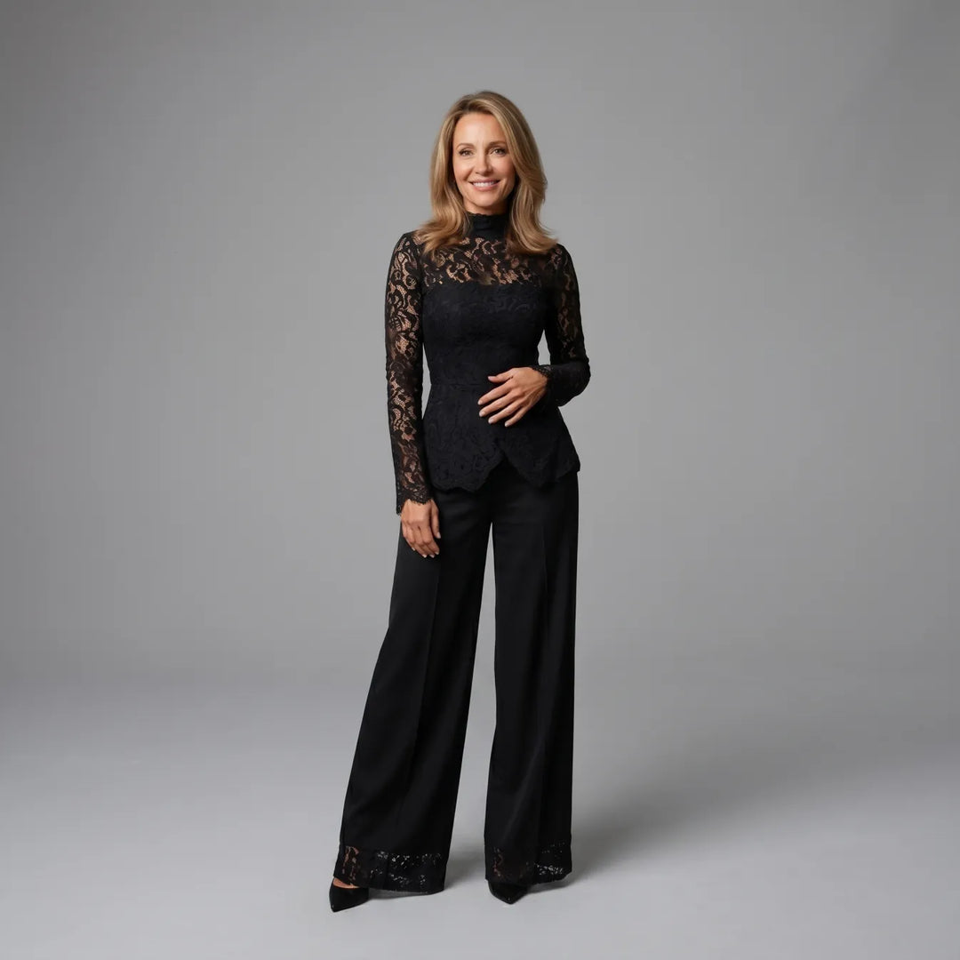 Black lace jumpsuit with long sleeves, styled in a studio with neutral gray backdrop.